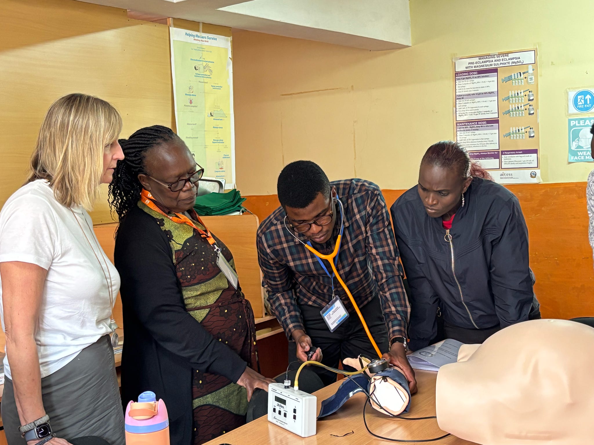Faculty demonstrating simulation equipment